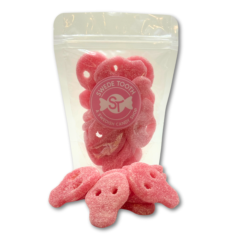 Pink skull-shaped Swedish sour gummies in a clear resealable bag